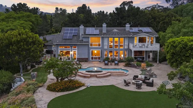 a front view of a house with garden and patio