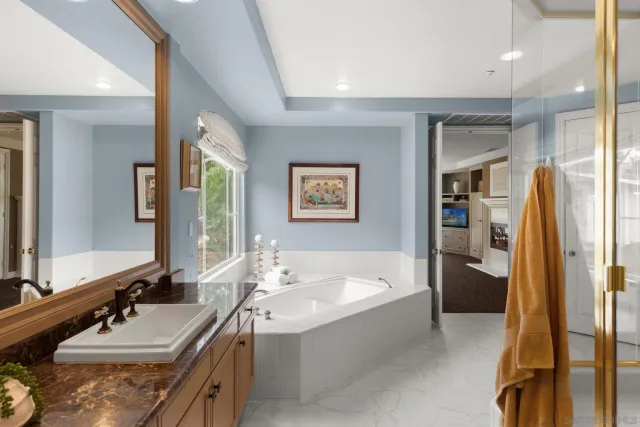 a room with pool table flat screen tv and windows