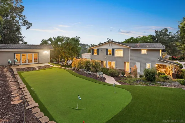 a front view of a house with a garden and a yard