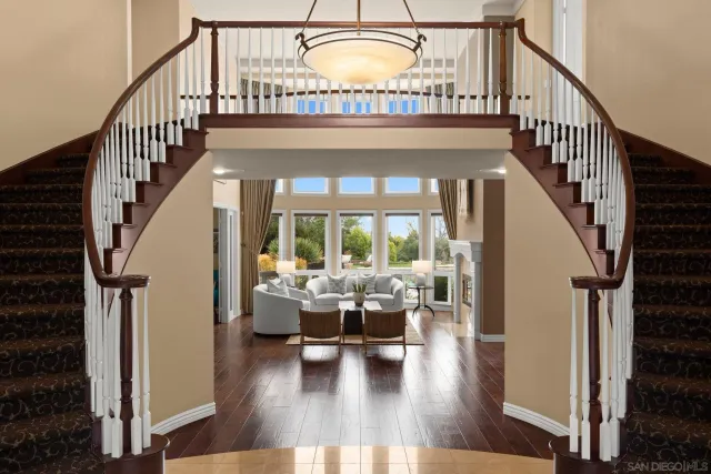 a living room with fireplace furniture and a large window