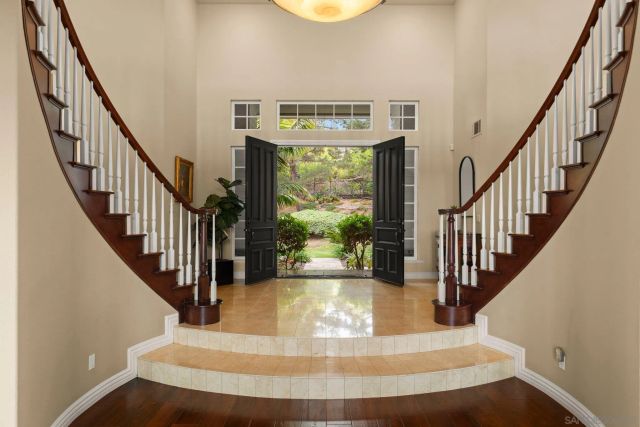a living room with fireplace furniture and a large window