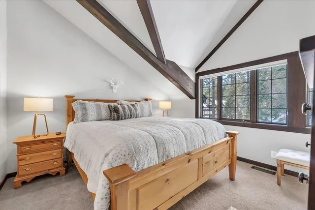 a spacious bedroom with a bed and a couch