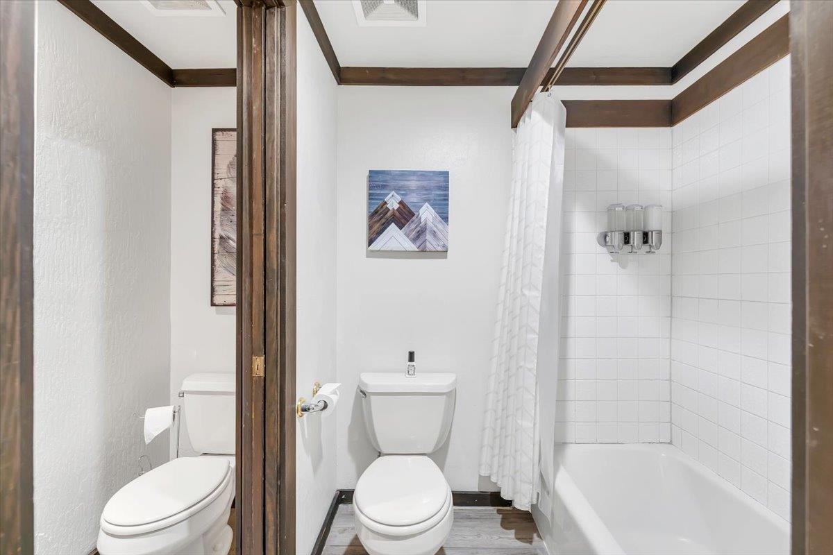 227 Olympic Vly Road, Unit 15 Olympic Valley, CA 96146 - Photo 17 of 28 a white toilet sitting next to a bathroom sink and shower