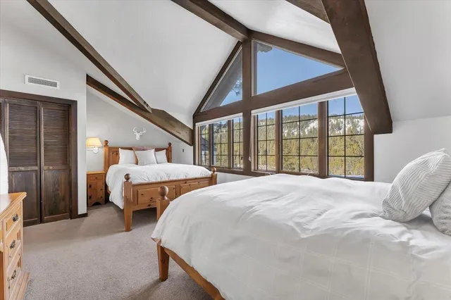 a bedroom with a large bed and a balcony view