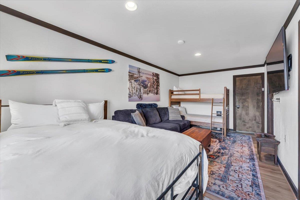 227 Olympic Vly Road, Unit 15 Olympic Valley, CA 96146 - Photo 22 of 28 a bed room with a bed and a large mirror