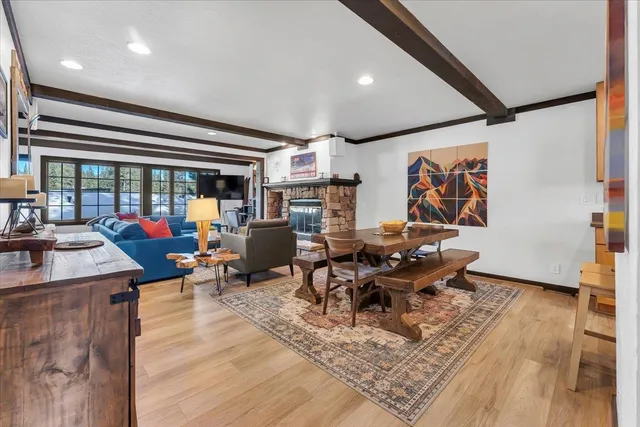a living room with furniture a rug and a large window