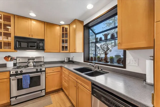 a kitchen that has a sink and a stove