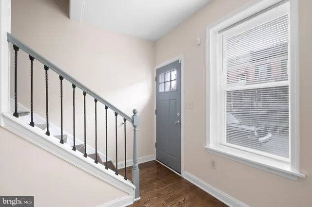 a view of staircase with white walls and a window
