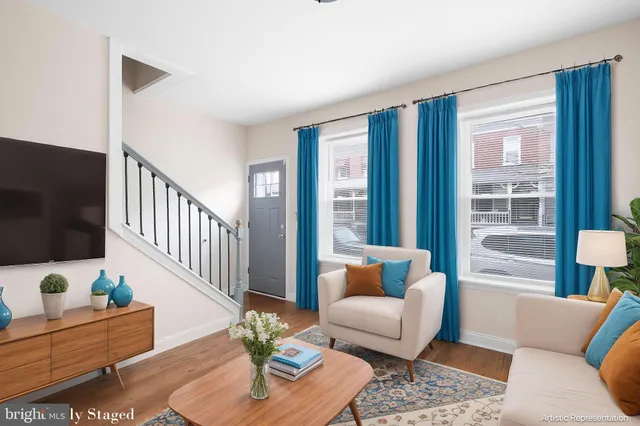 a living room with furniture and a flat screen tv