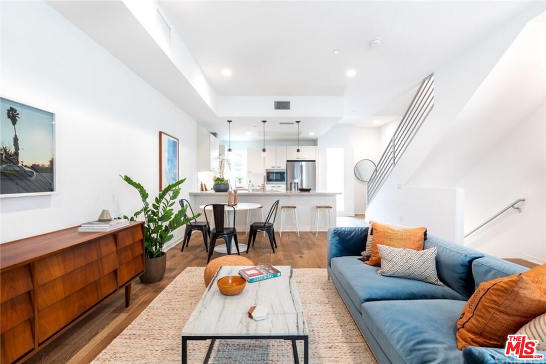 4821 1/2 Craner Avenue North Hollywood, CA 91601 - Photo 3 of 14 a living room with furniture kitchen view and a potted plant