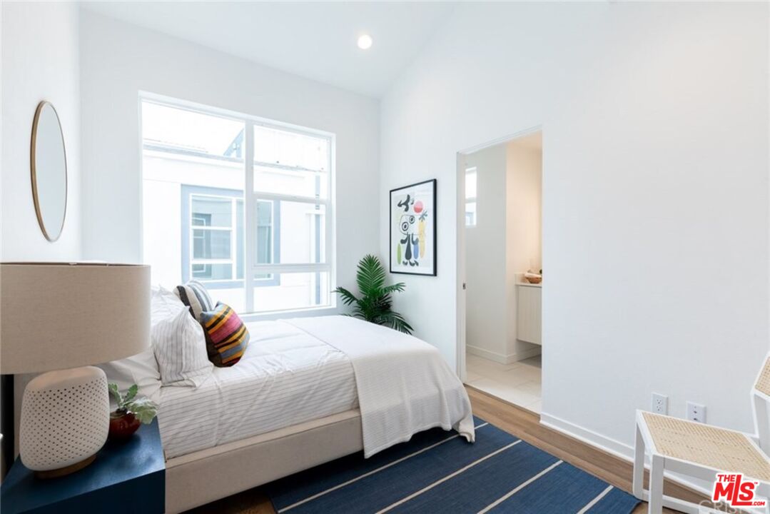 4821 1/2 Craner Avenue North Hollywood, CA 91601 - Photo 7 of 14 a bedroom with a bed and wooden floor