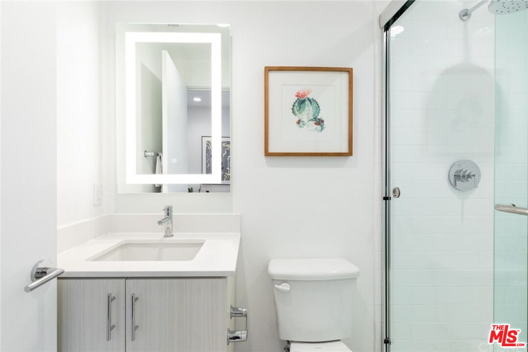 4821 1/2 Craner Avenue North Hollywood, CA 91601 - Photo 10 of 14 a bathroom with a sink mirror and toilet