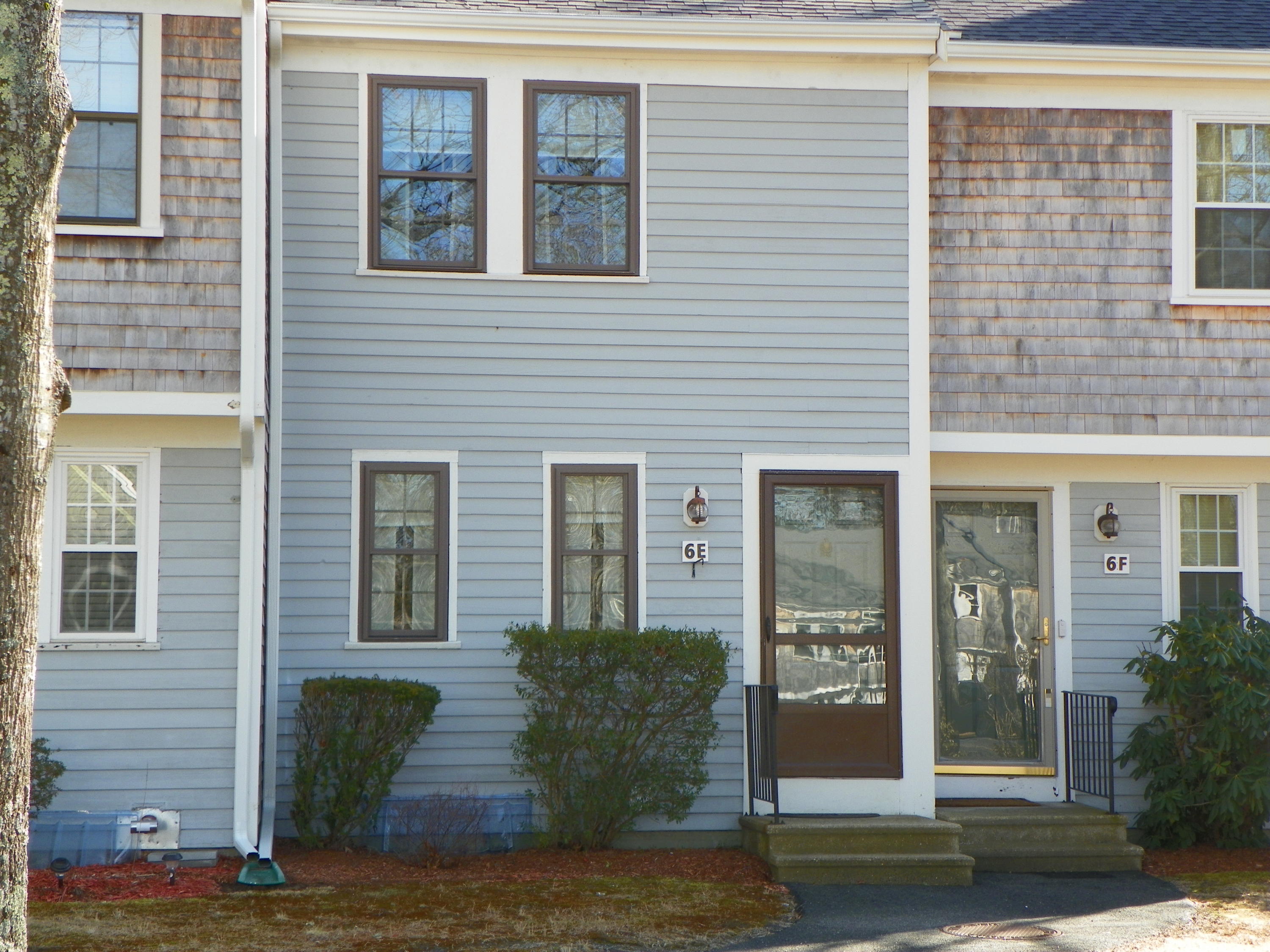 300 Falmouth Road, Unit 6E Mashpee, MA 02649 - Photo 1 of 32 a front view of a house with a yard