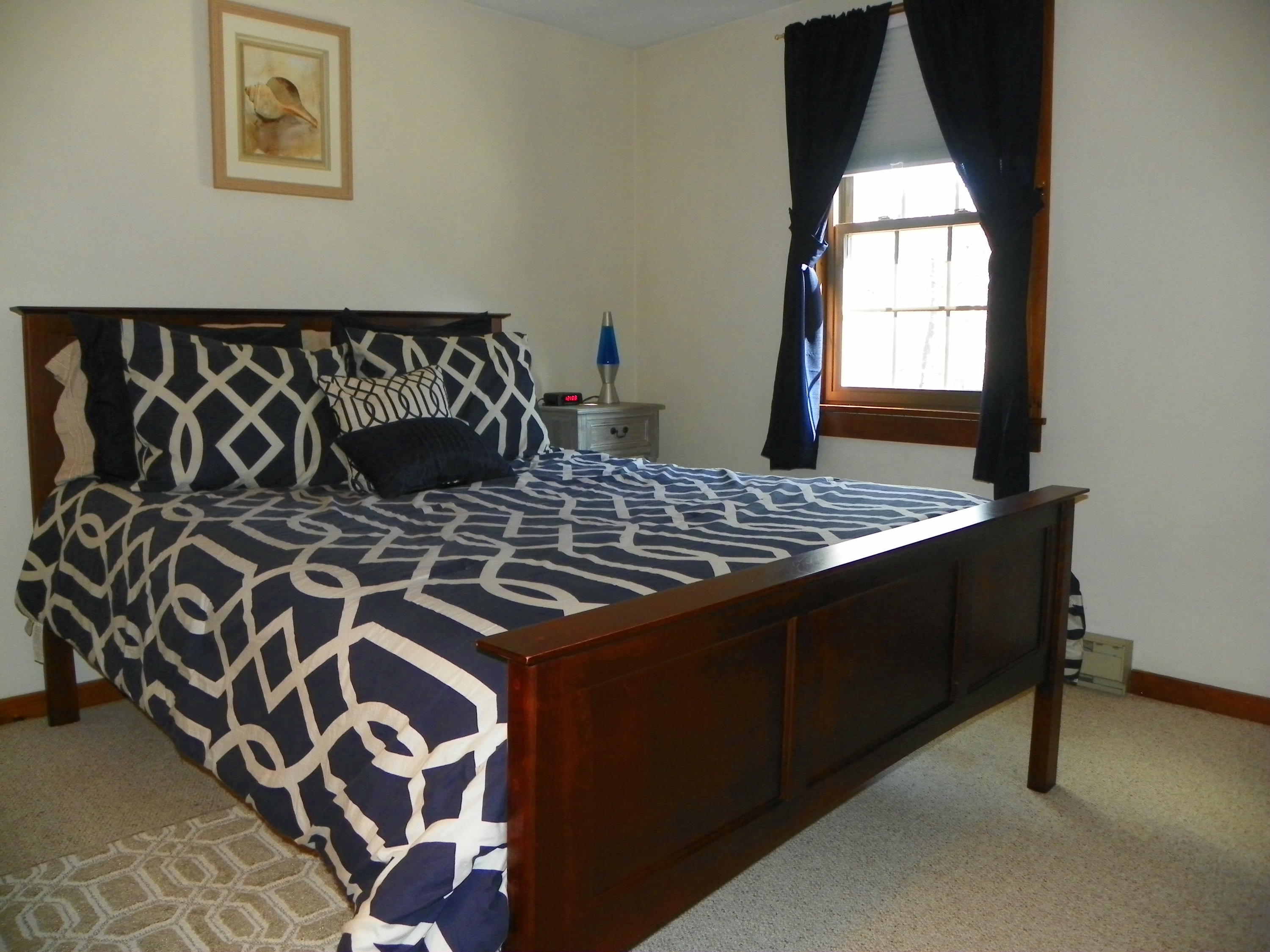 300 Falmouth Road, Unit 6E Mashpee, MA 02649 - Photo 20 of 32 a bed sitting in a bedroom next to a window