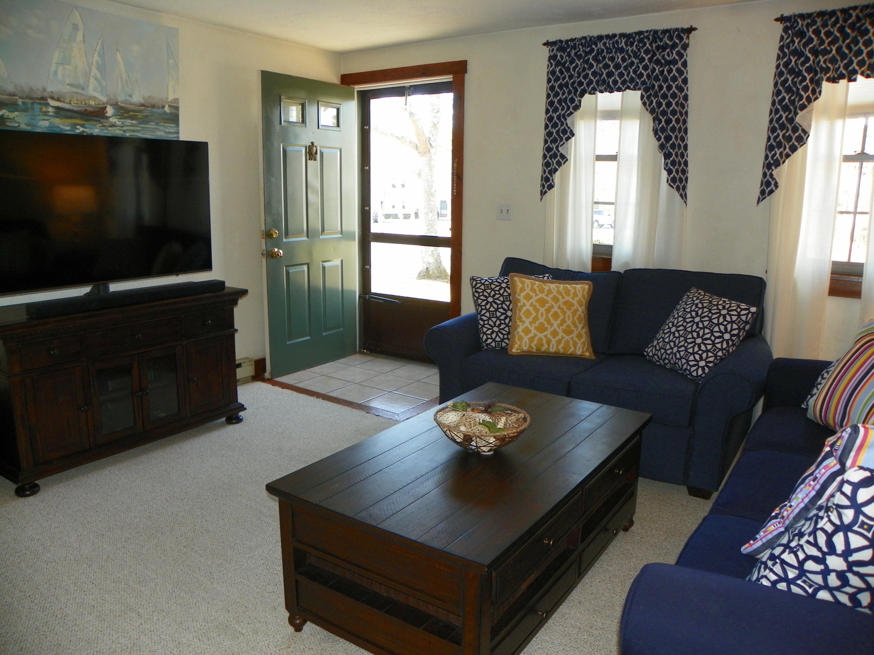 300 Falmouth Road, Unit 6E Mashpee, MA 02649 - Photo 4 of 32 a living room with furniture and a flat screen tv