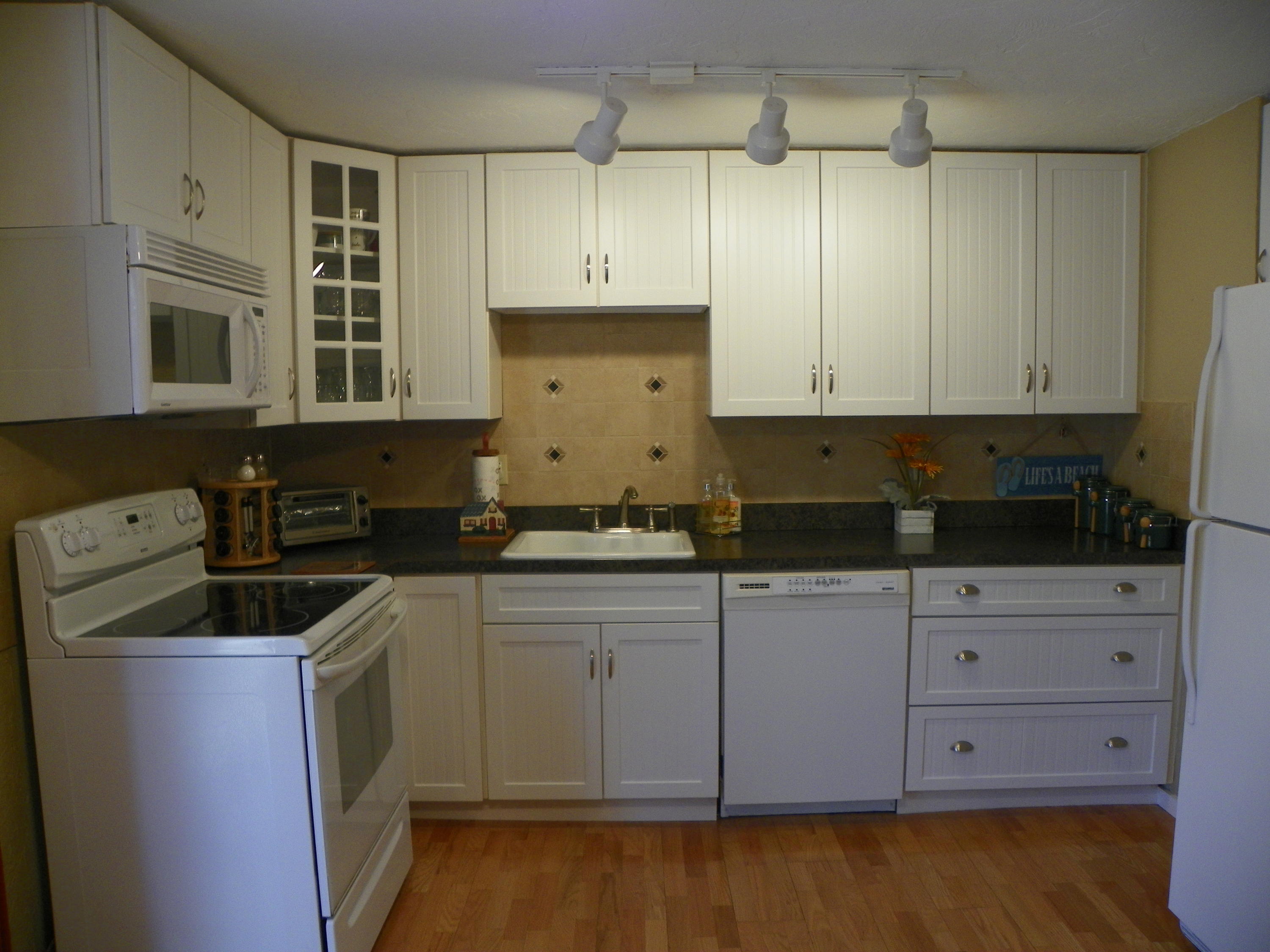 300 Falmouth Road, Unit 6E Mashpee, MA 02649 - Photo 9 of 32 a kitchen with stainless steel appliances granite countertop a sink a stove and a refrigerator
