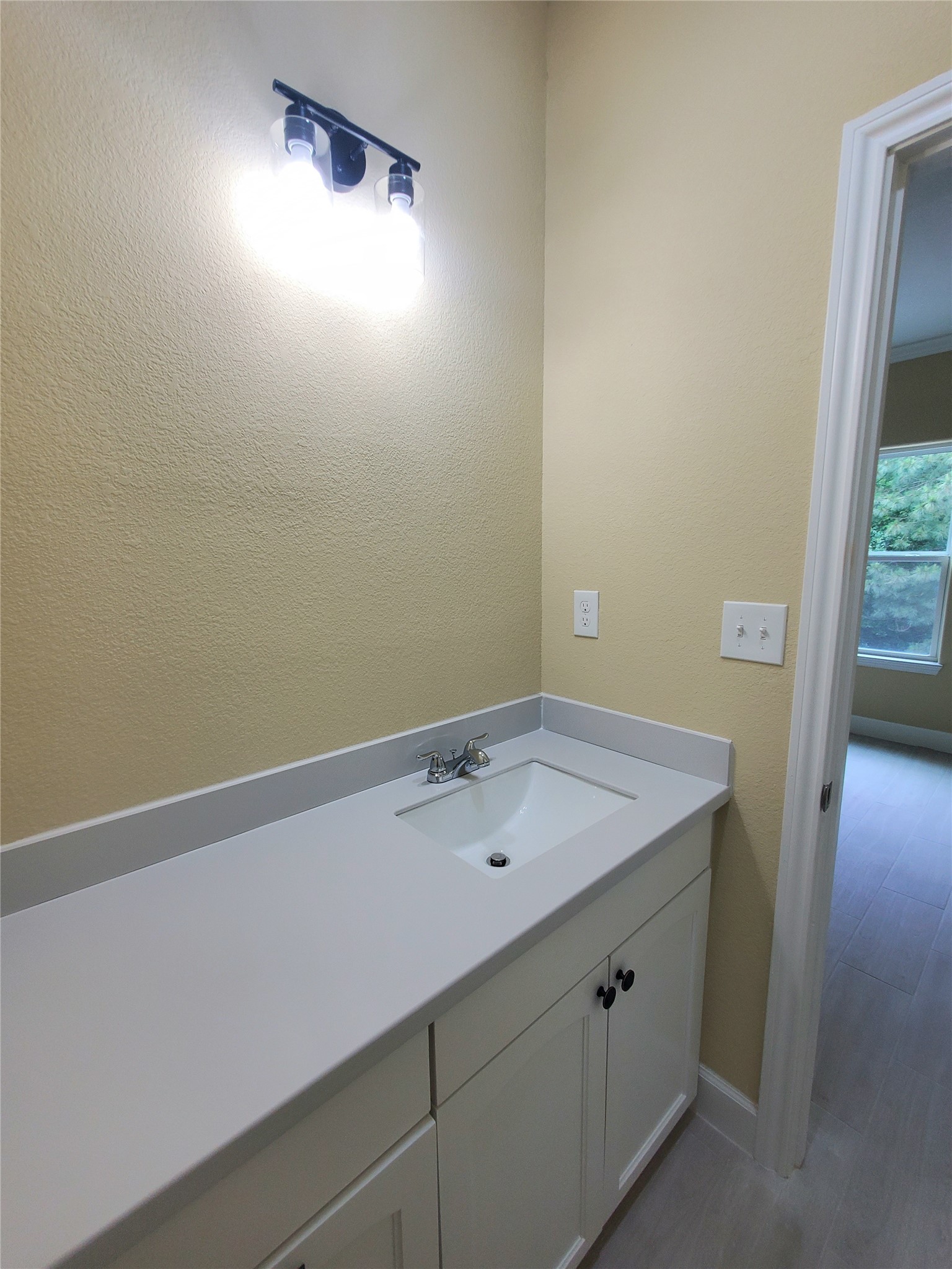 1306 North 9th Street Conroe, TX 77301 - Photo 20 of 47 a bathroom with a sink and vanity