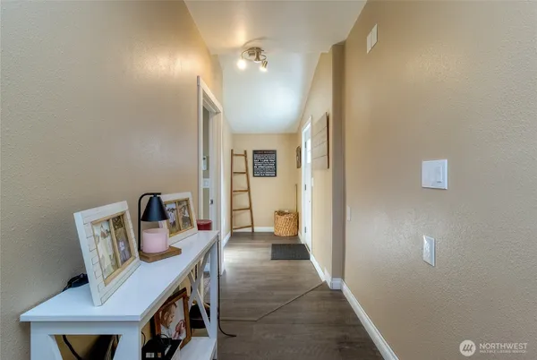 a view of a hallway to a livingroom with furniture