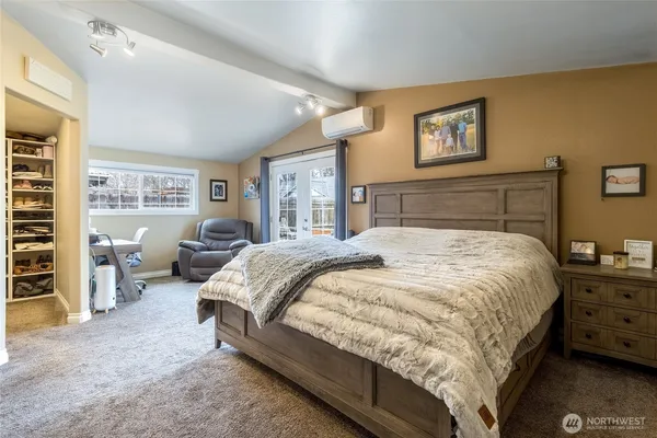 a bedroom with a bed couch and a window