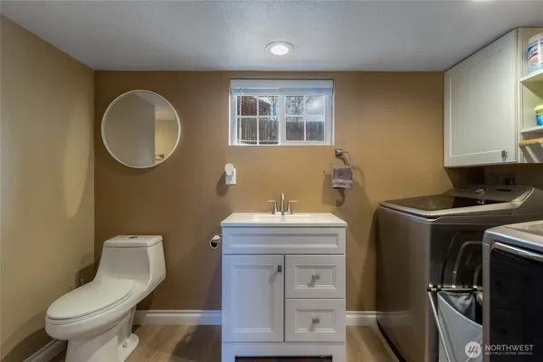 a bathroom with a toilet and a mirror