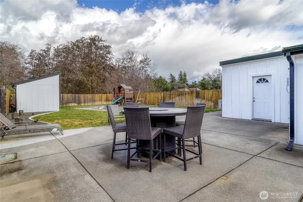 a view of a backyard with a garden and entertaining space