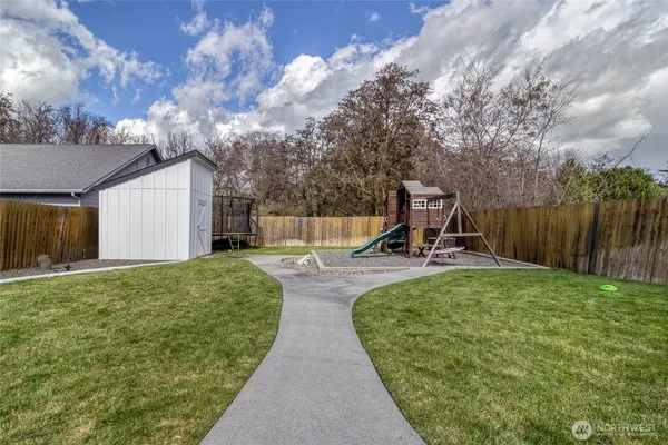 a view of a house with patio and a garden