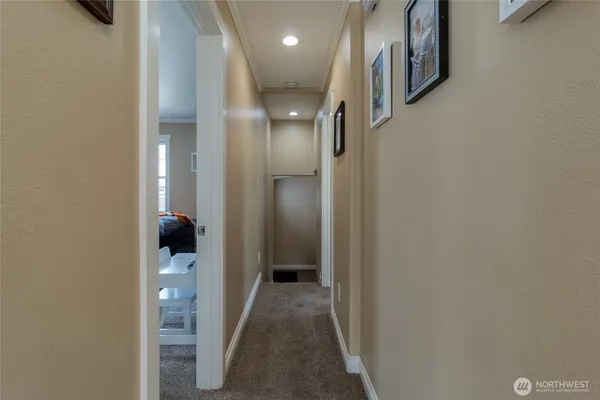 a view of a hallway with a bathroom