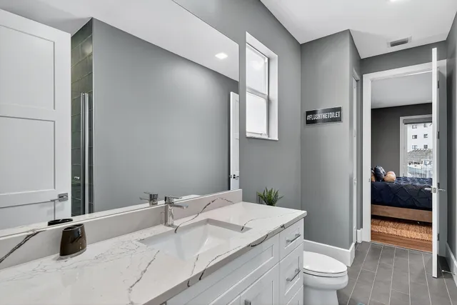 a view of a balcony with chairs and potted plant on the roof