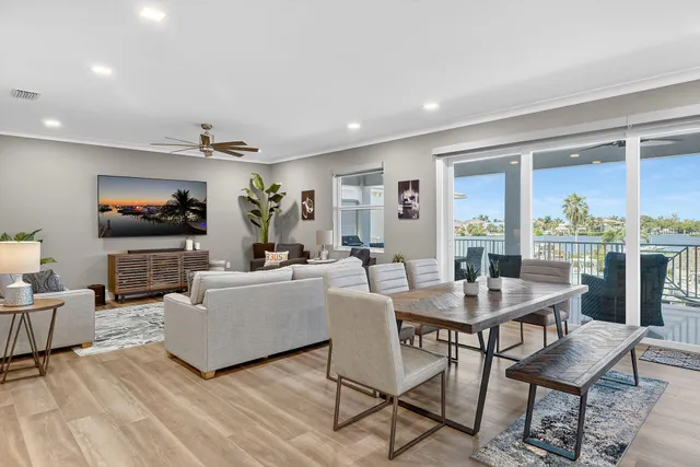 a living room with furniture and a view of kitchen