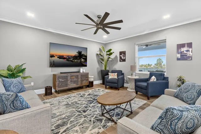 a dining room with wooden floor and glass windows