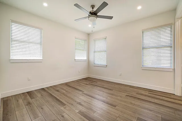 a view of a livingroom with a window and wooden floor