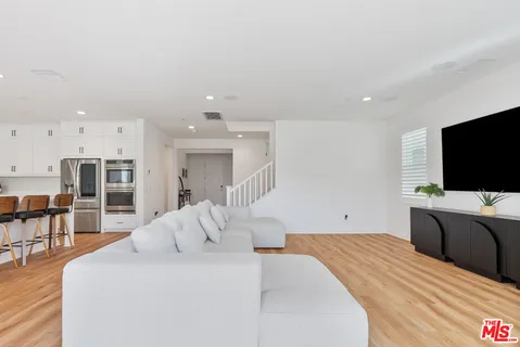 a kitchen with stainless steel appliances kitchen island granite countertop a sink and cabinets