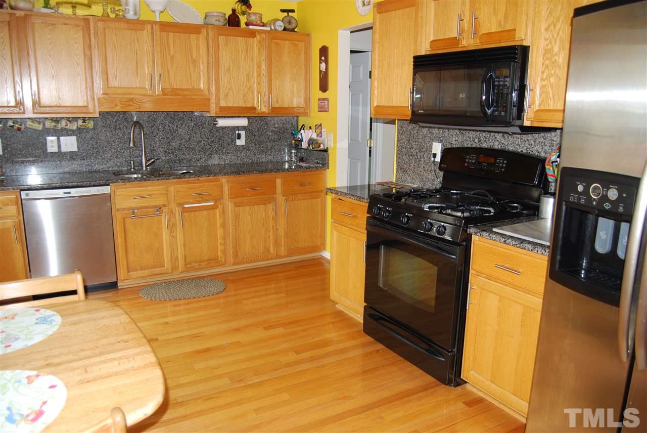 4301 Mantua Way Raleigh, NC 27604 - Photo 8 of 20 a kitchen with stainless steel appliances granite countertop a stove a sink and a microwave
