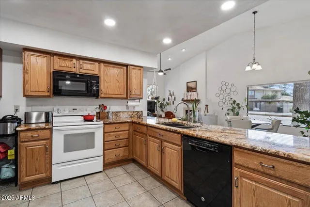 a kitchen with stainless steel appliances granite countertop a sink and dishwasher a stove top oven with wooden floor