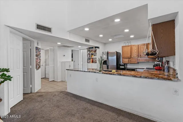 a kitchen with stainless steel appliances a refrigerator and a sink