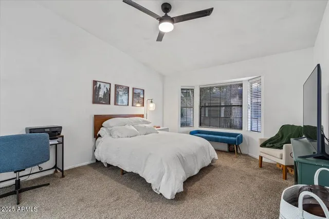 a bed room with a bed window and a chair