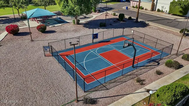 an aerial view of a tennis ground with a white house