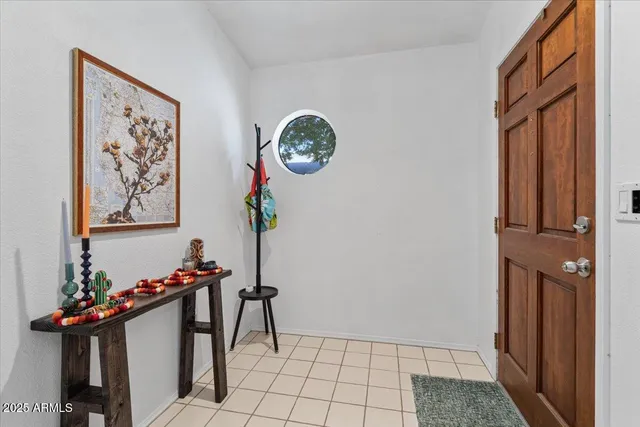 a view of an entryway with a flower pot and a table