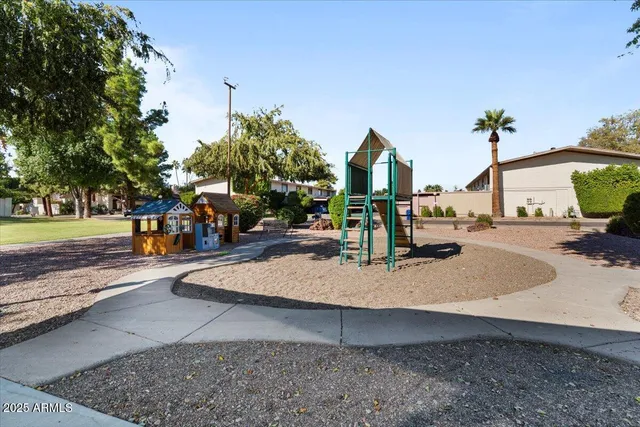 a view of a park with swings and slides