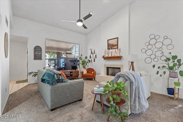 a living room with fireplace furniture and a chandelier