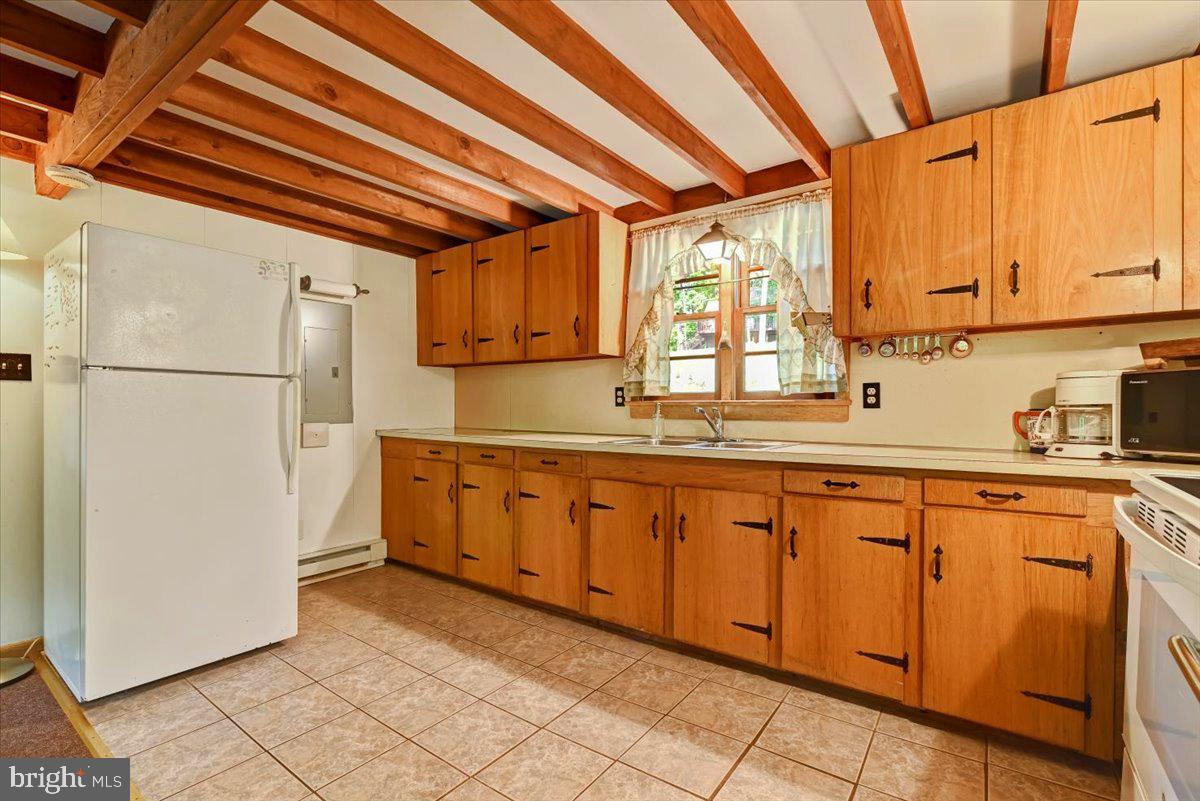 112 Beechwood Cove Road Greentown, PA 18426 - Photo 11 of 59 a kitchen with sink a refrigerator and cabinets