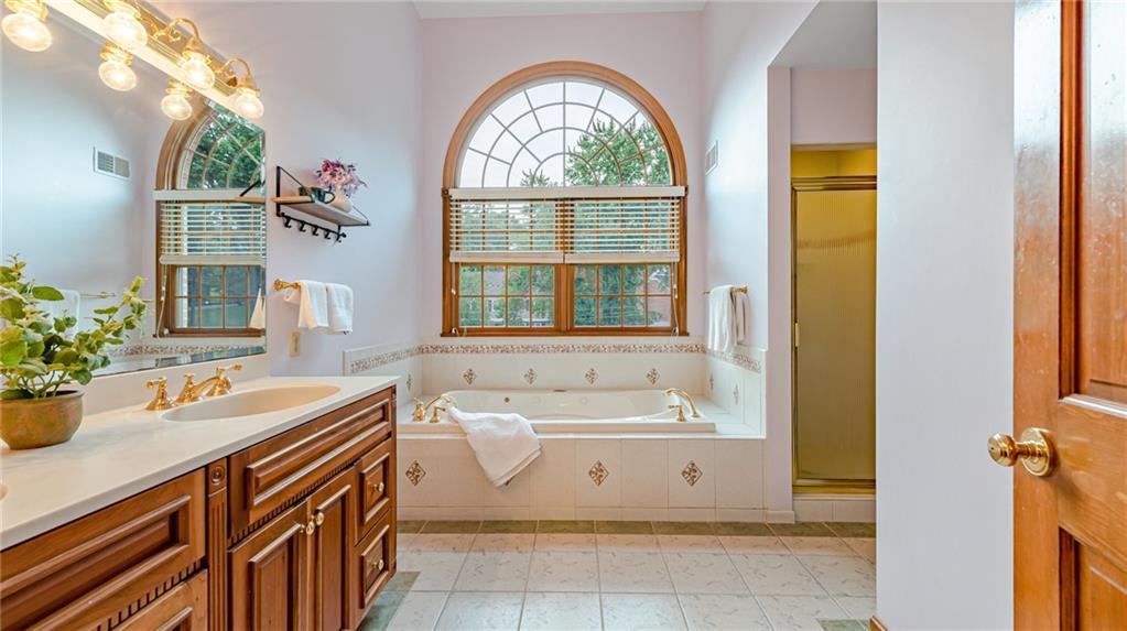 110 Lamar Road Pittsburgh, PA 15241 - Photo 16 of 43 a bathroom with a sink a mirror and a bathtub