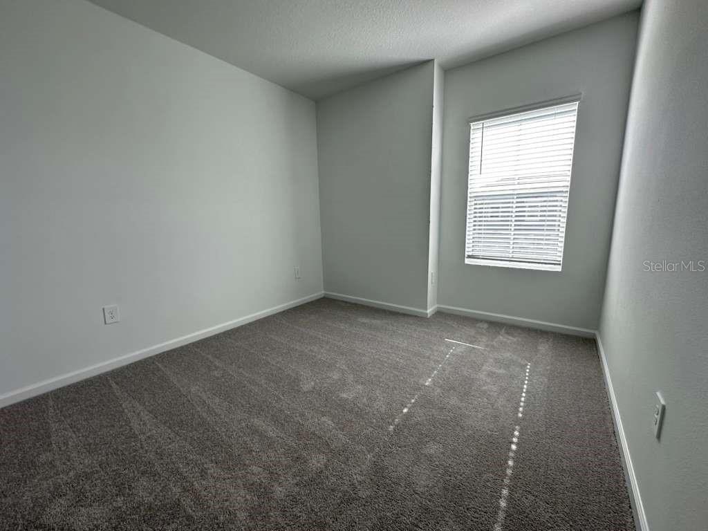 2729 Skyline Loop Kissimmee, FL 34758 - Photo 11 of 20 an empty room with a window