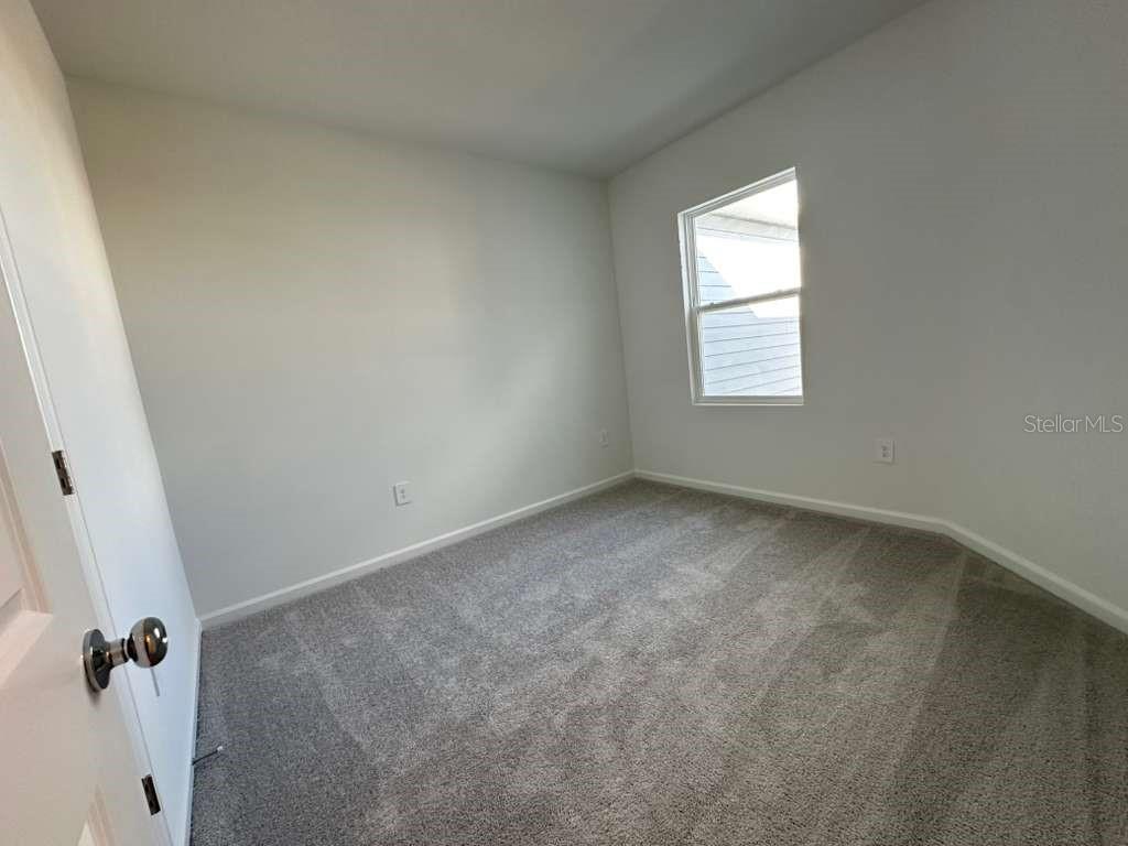 2729 Skyline Loop Kissimmee, FL 34758 - Photo 12 of 20 an empty room with a window