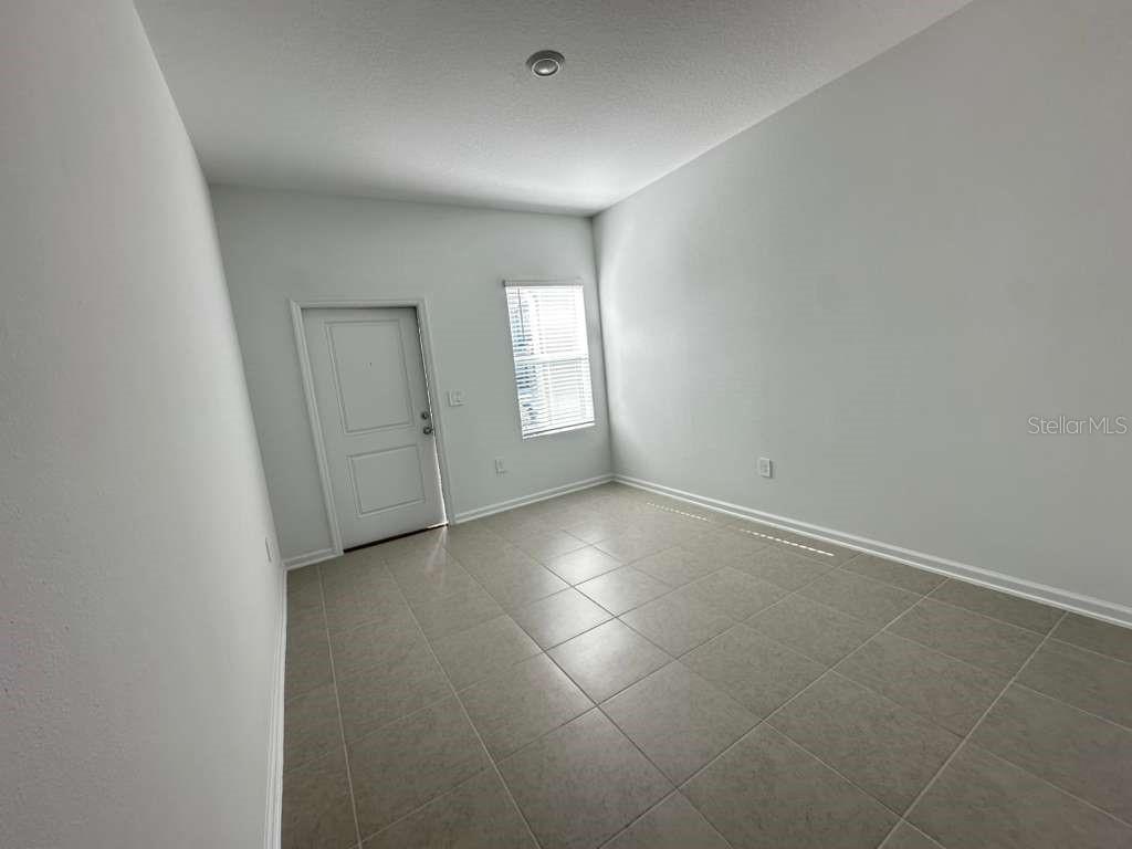 2729 Skyline Loop Kissimmee, FL 34758 - Photo 15 of 20 an empty room with windows and entrance