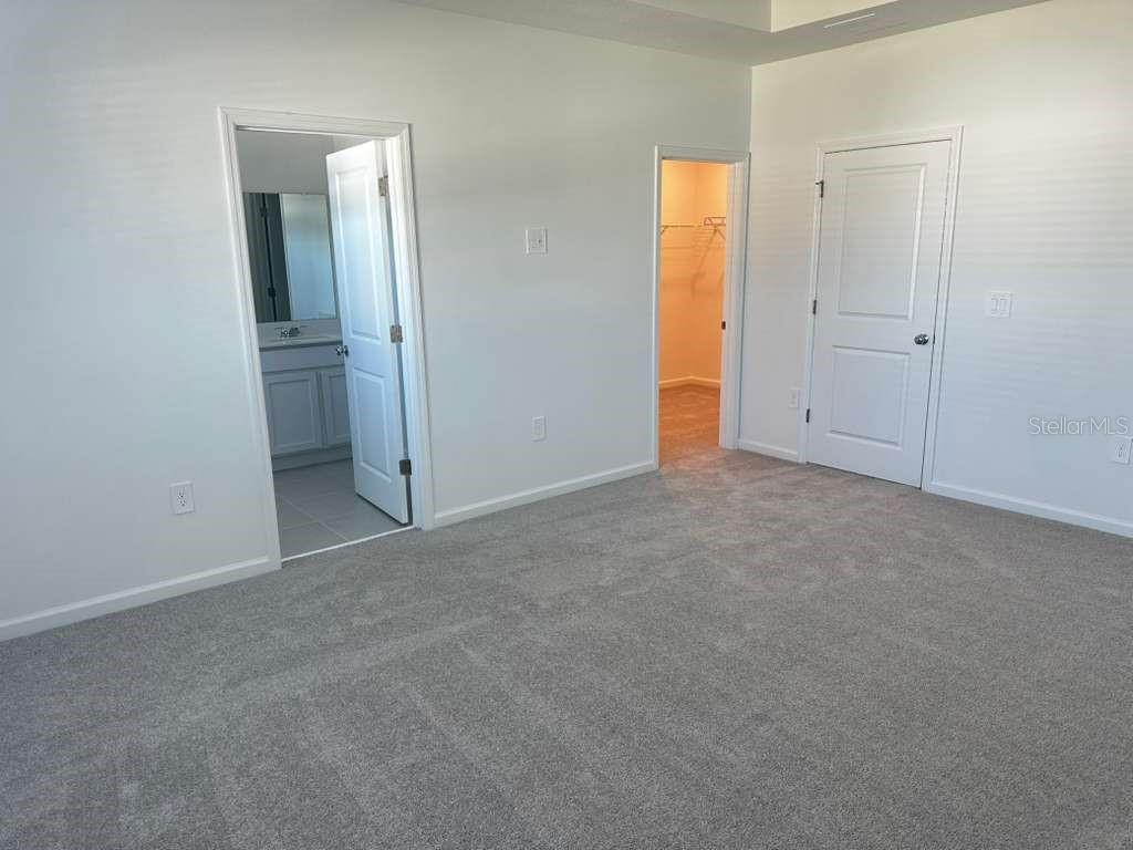 2729 Skyline Loop Kissimmee, FL 34758 - Photo 17 of 20 an empty room with closet and a bathroom