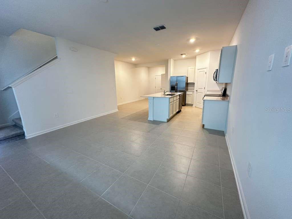 2729 Skyline Loop Kissimmee, FL 34758 - Photo 5 of 20 a view of kitchen with kitchen island a sink a stove and a refrigerator