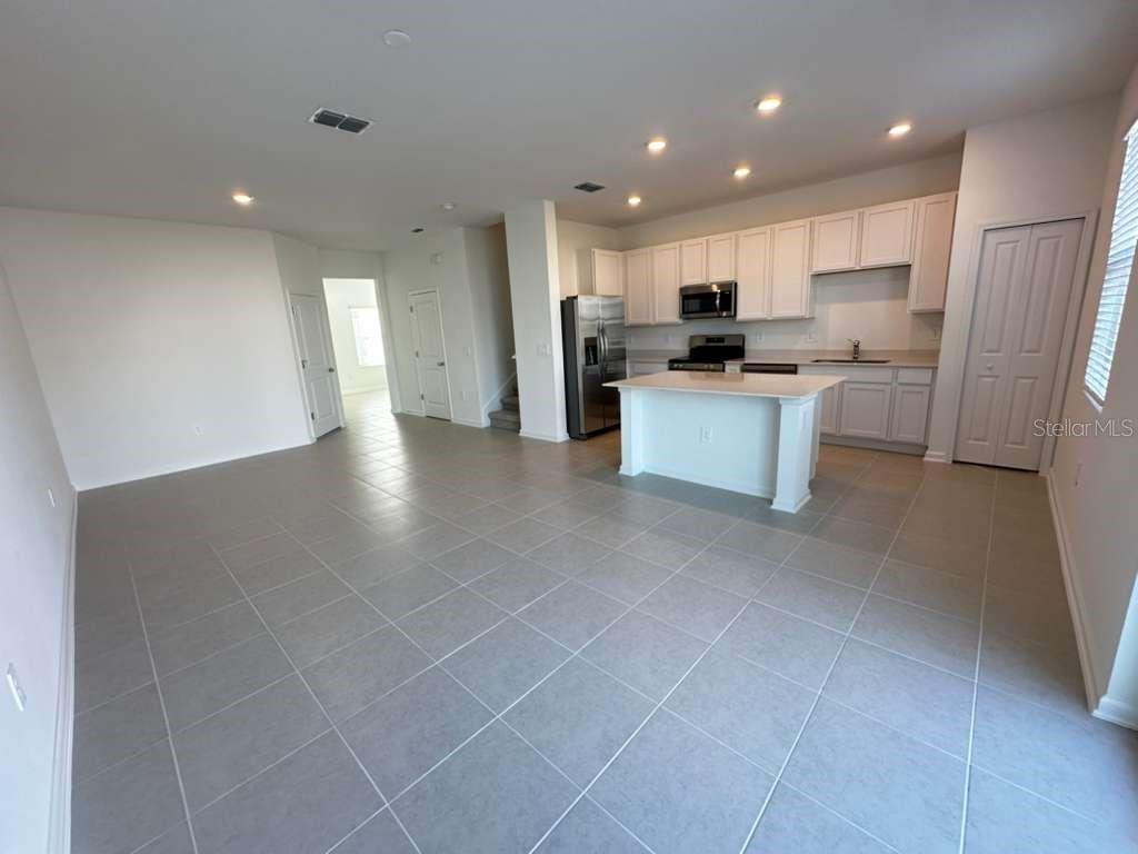 2729 Skyline Loop Kissimmee, FL 34758 - Photo 6 of 20 a view of kitchen with kitchen island stainless steel appliances refrigerator sink and cabinets