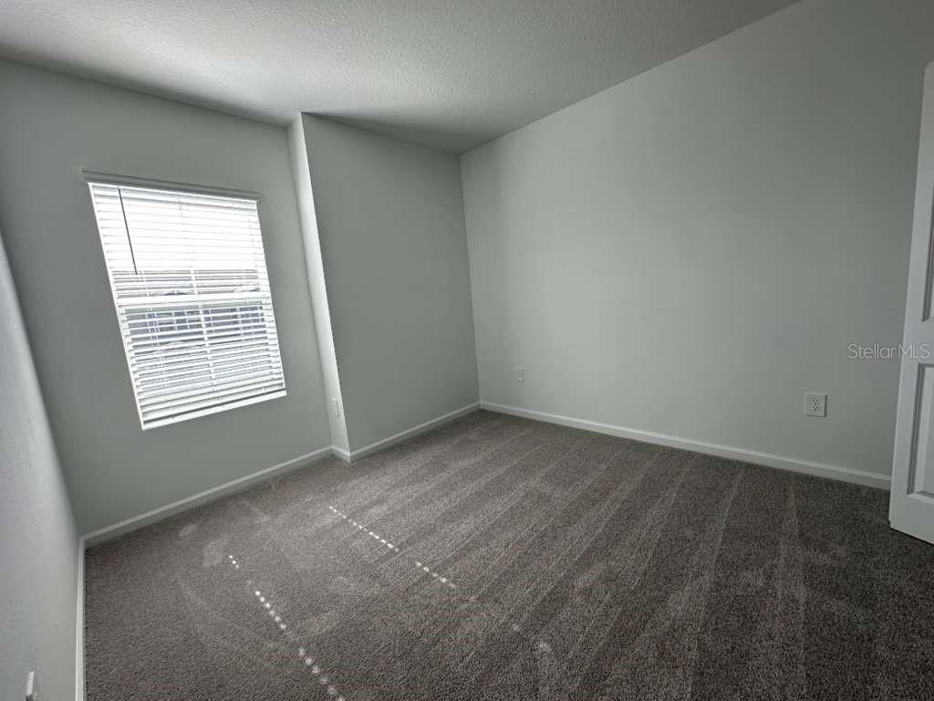 2729 Skyline Loop Kissimmee, FL 34758 - Photo 10 of 20 an empty room with a window