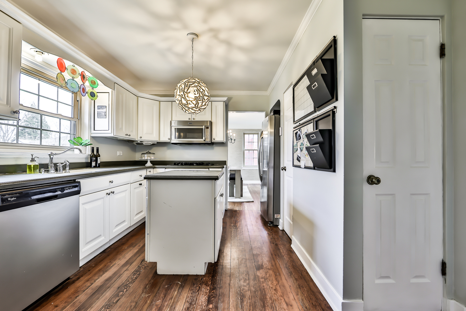 438 Longcommon Road Riverside, IL 60546 - Photo 6 of 16 a kitchen with stainless steel appliances granite countertop a refrigerator a stove and a wooden floors